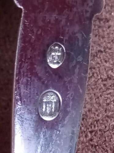 Halmark on ladle with curled leaf